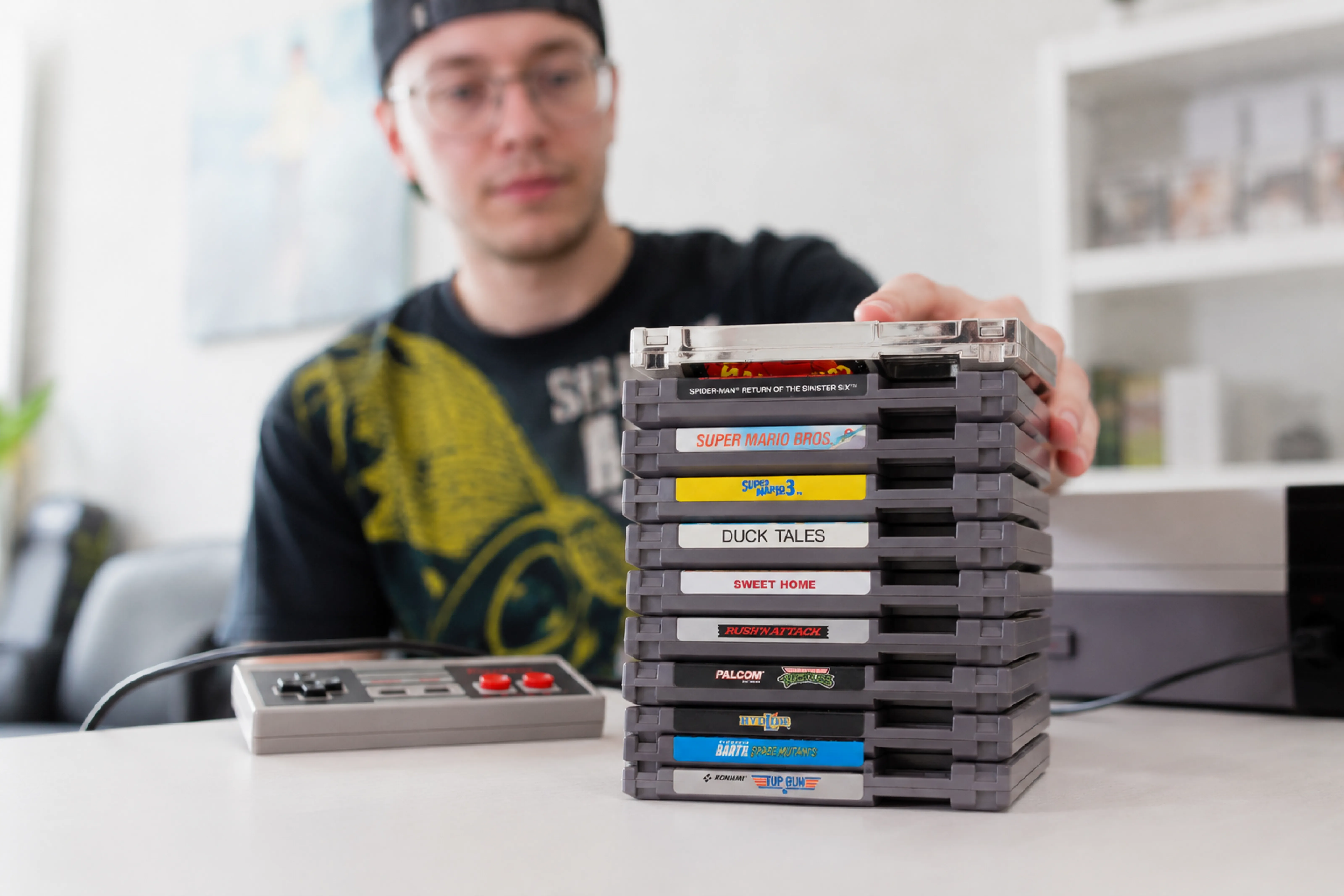 Dylan Kekacs, owner of The CT Picker, sorting through a game collection at his workspace